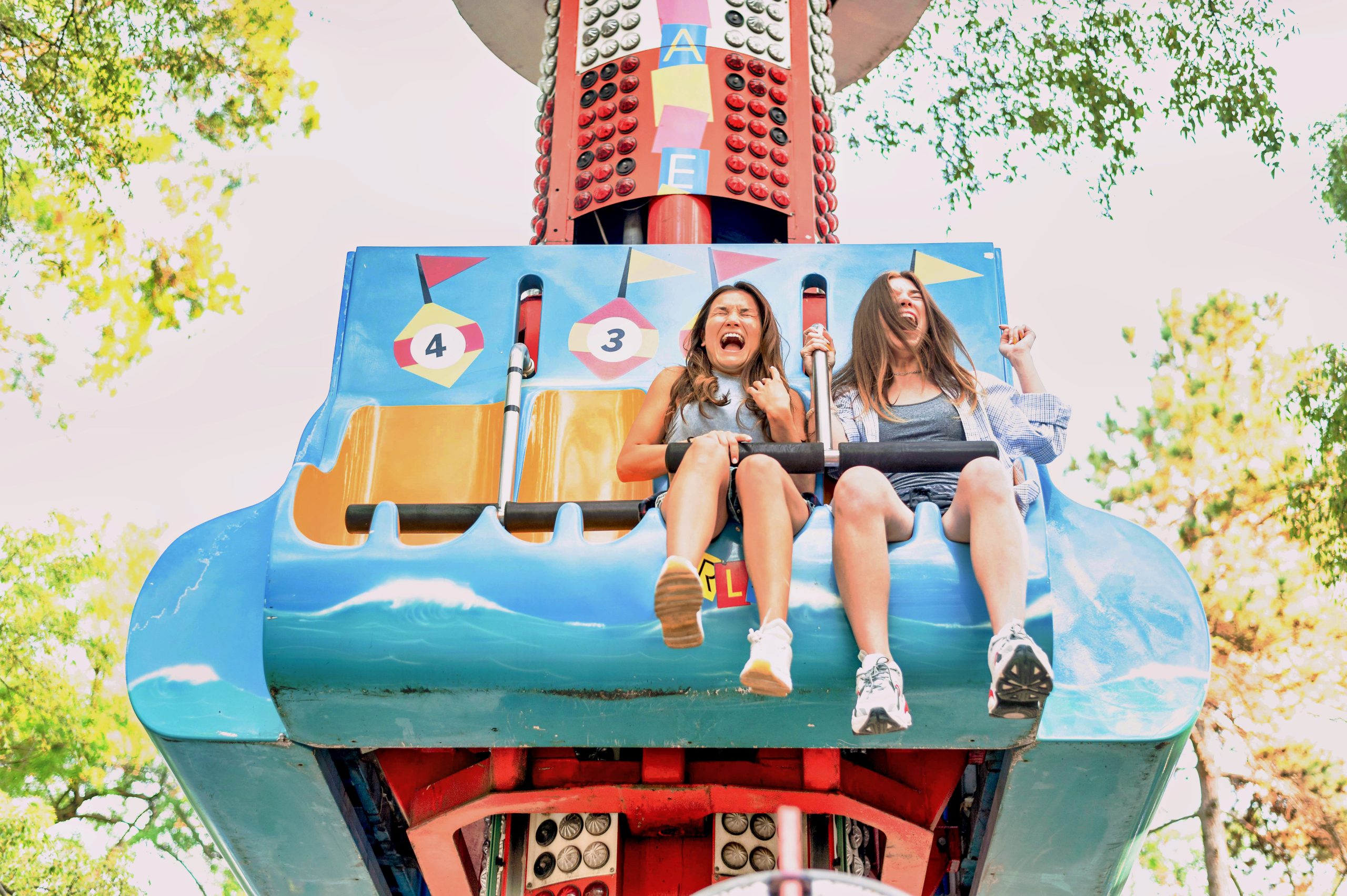 smiley-female-friends-having-fun-amusement-park_PfC_IAPPA_v1.0