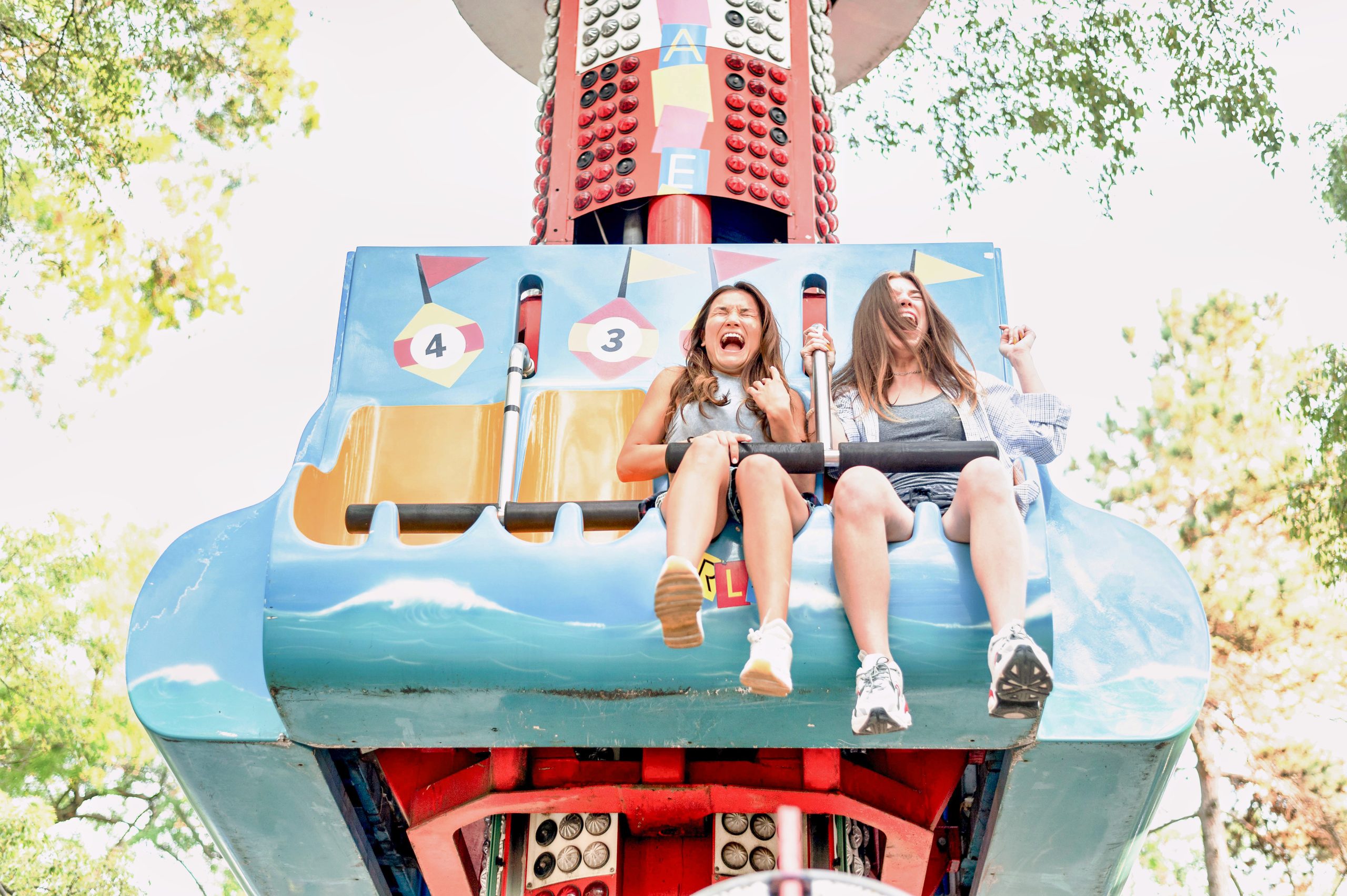 smiley-female-friends-having-fun-amusement-park_PfC_Pro