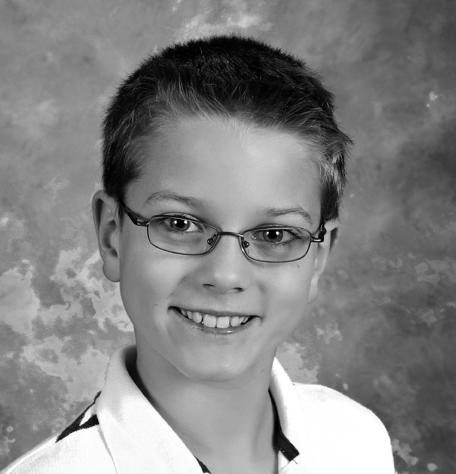 Shown here is a portrait of a nine year old boy. Image is like a school picture or yearbook photograph.