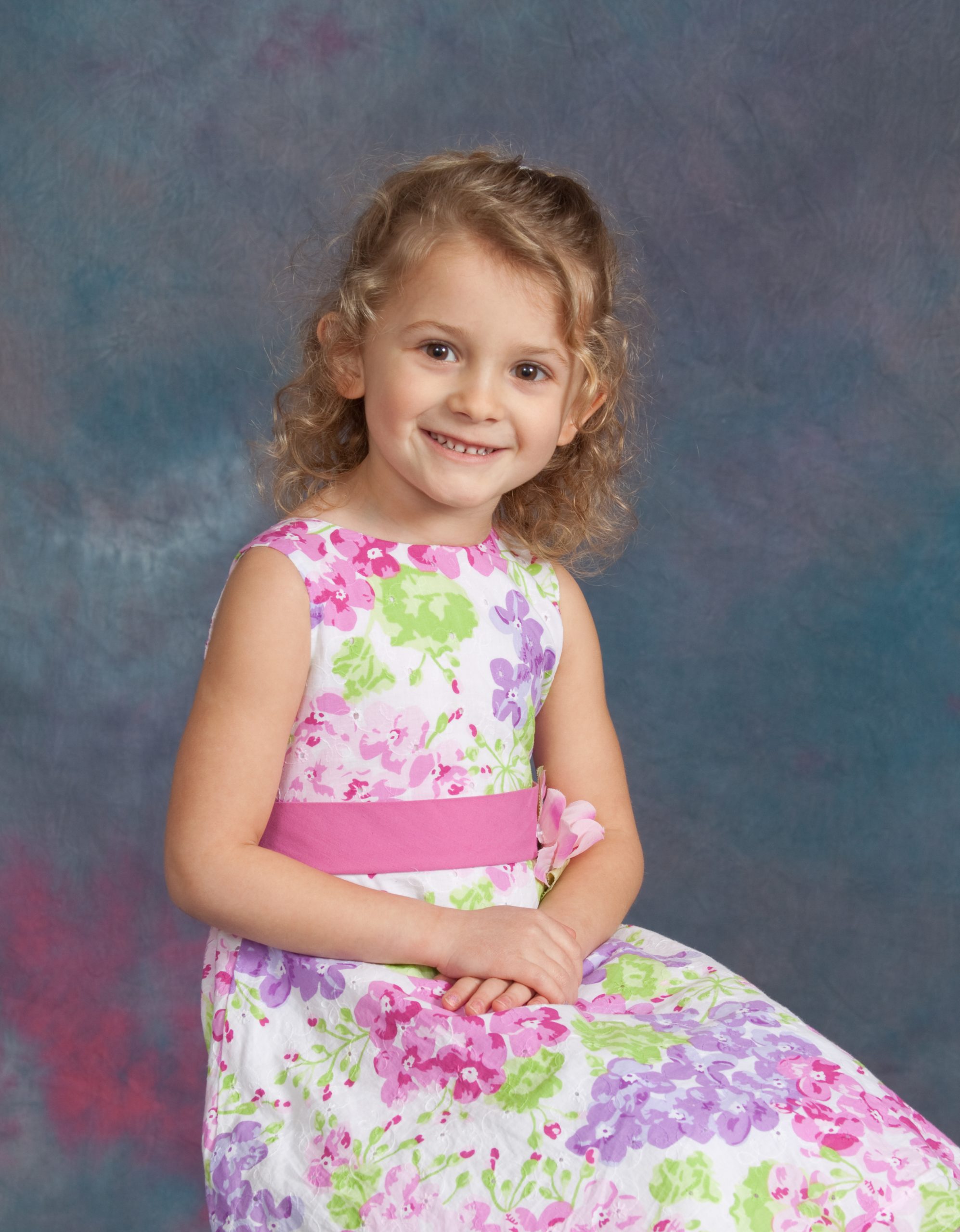 Portrait of a four-year-old girl with against a studio background.  Model is smiling and quite happy.See other related images here: